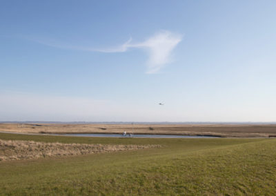 Die Insel Baltrum und im Hintergrund ein startendes Flugzeug